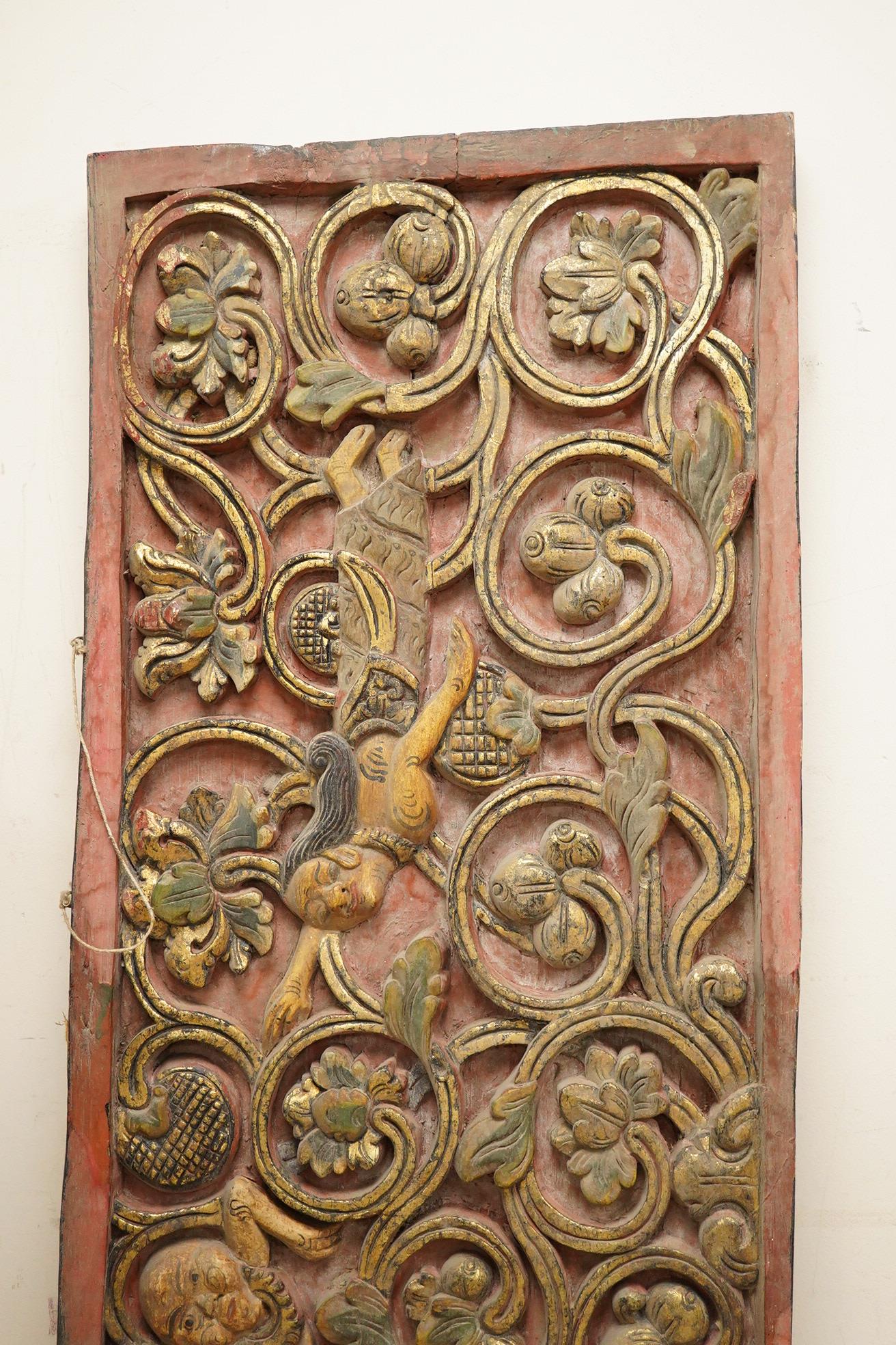 A Balinese partially gilt carved wood panel, 40 x 111cm
